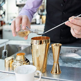 A bartender creates a craft cocktail