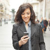 A businesswoman looks at her smartphone